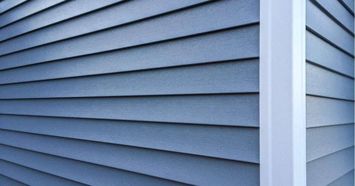 close up view of blue vinyl siding on exterior of home 